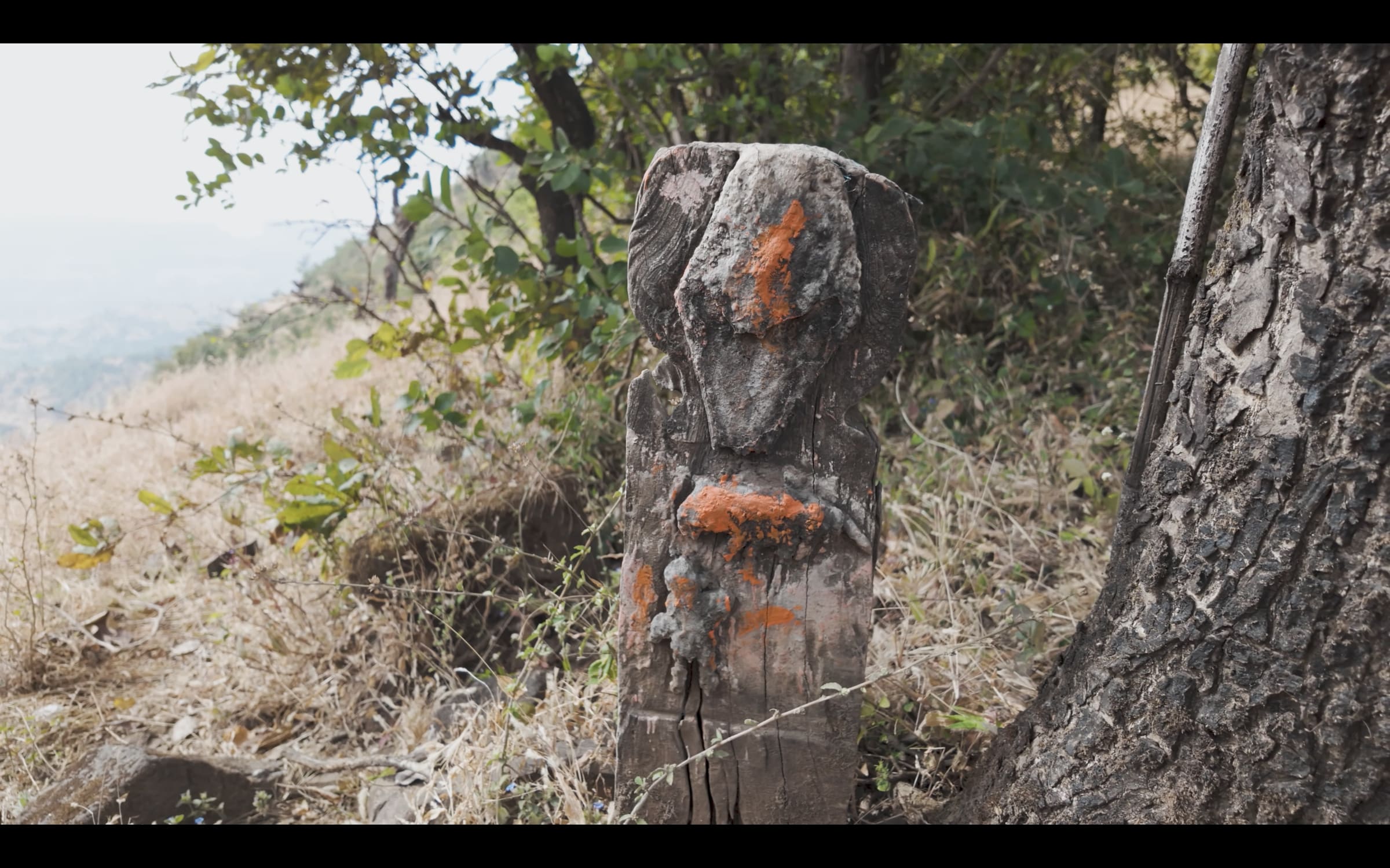 Wayside tribal shrine with sindoor, shells and coins